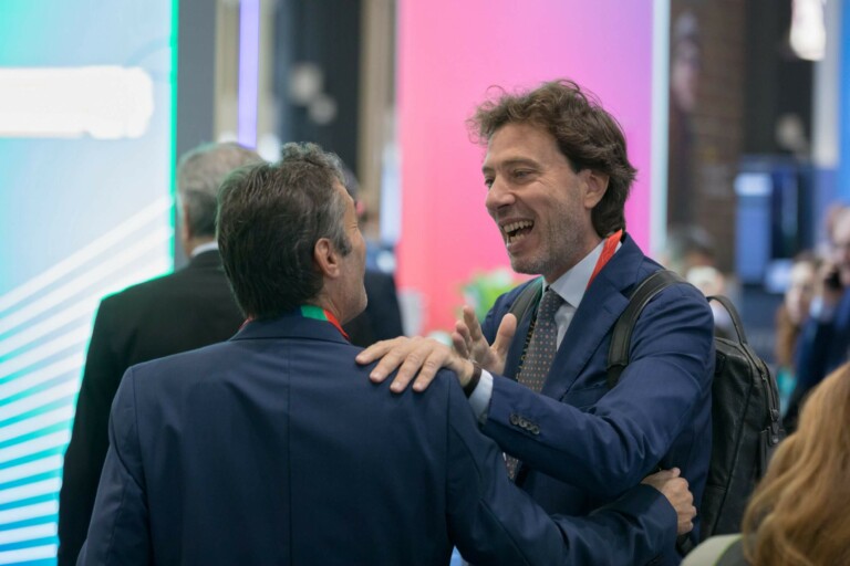 Two men in suits engaged in conversation at the EACTS Annual Meeting.